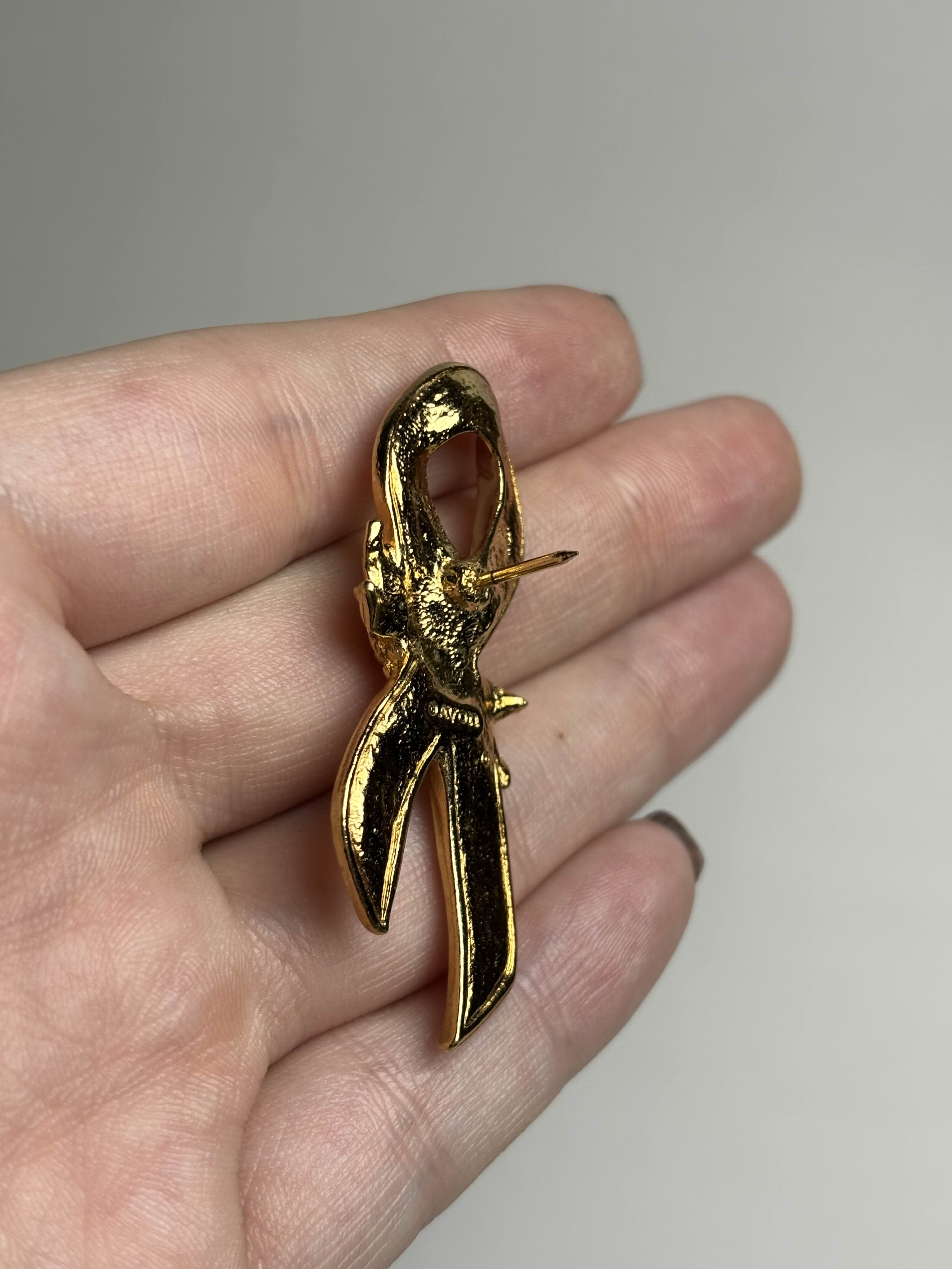 Back of breast cancer awareness ribbon brooch showing pin