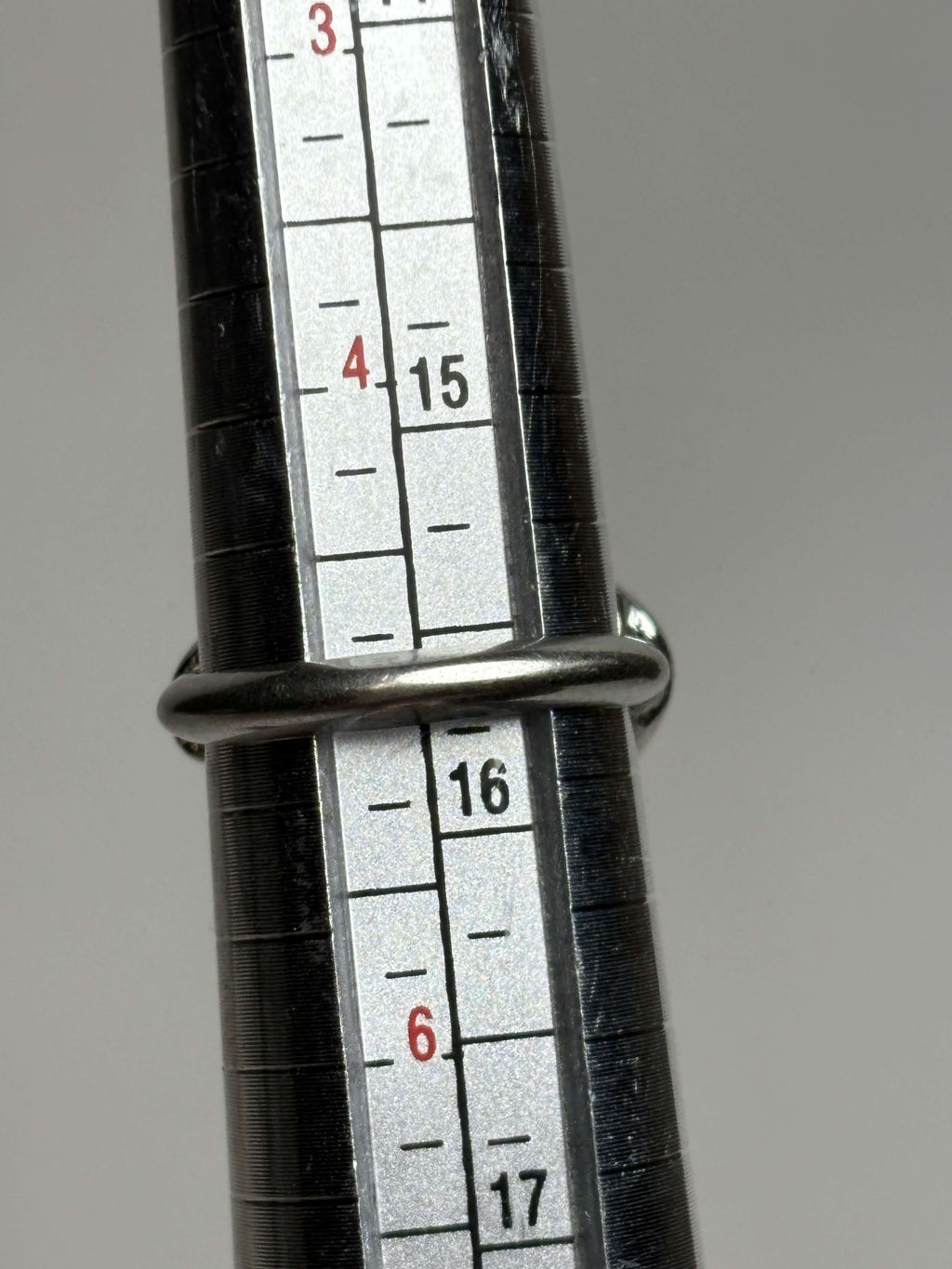 Ring showing size on a neutral background