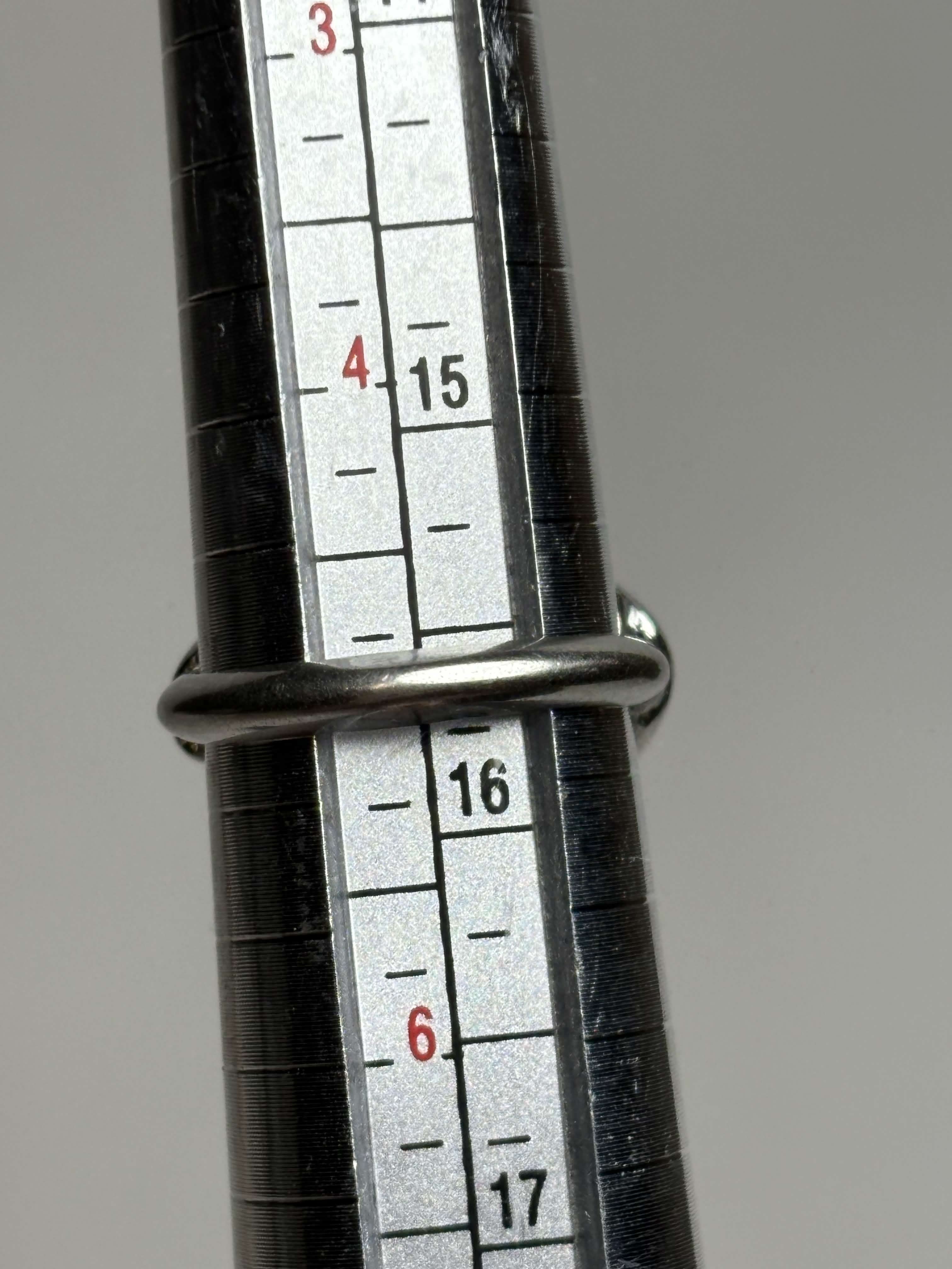 Ring showing size on a neutral background