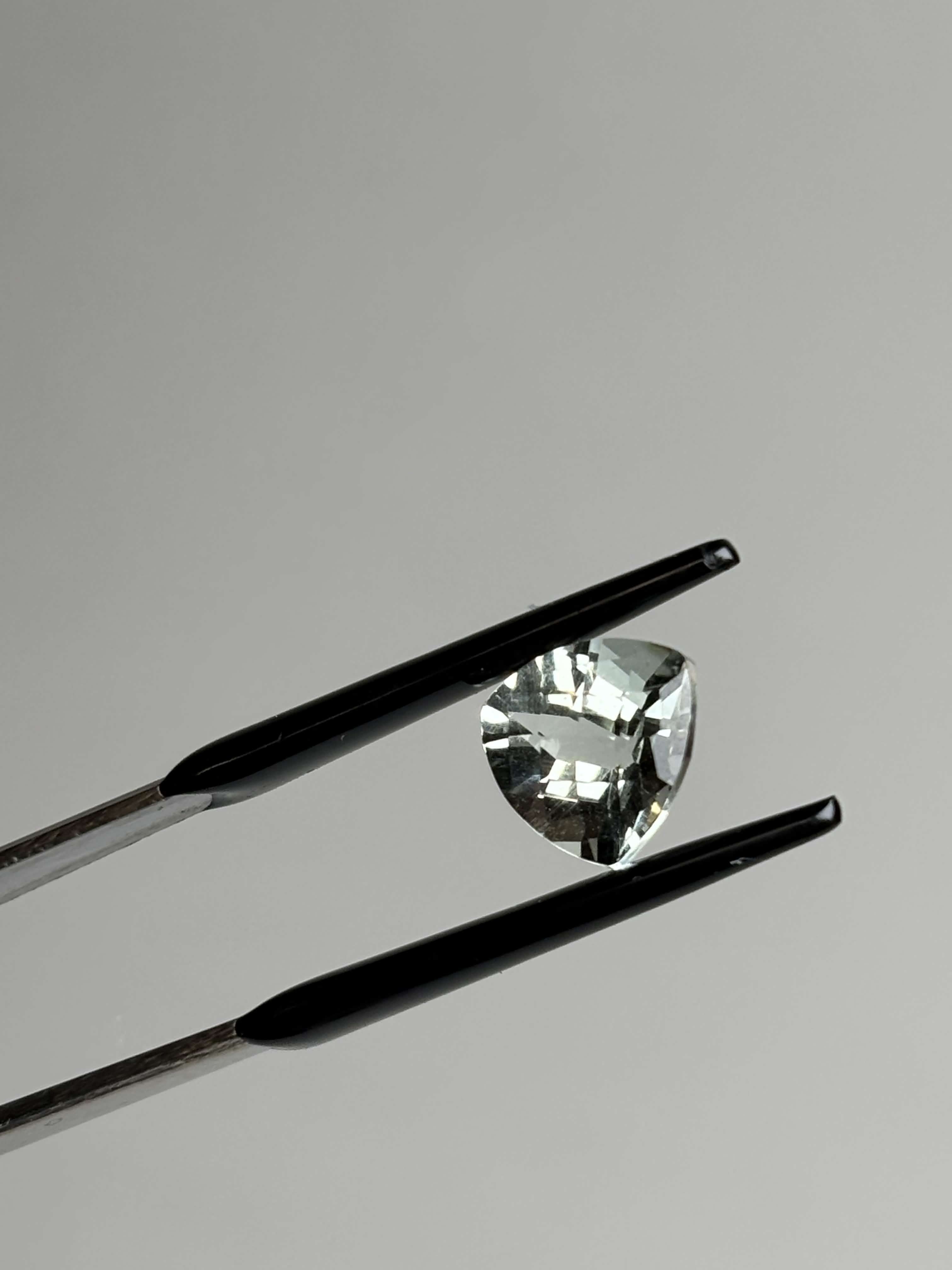 Front of trillion cut (triangular) light green stone 8 mm in size