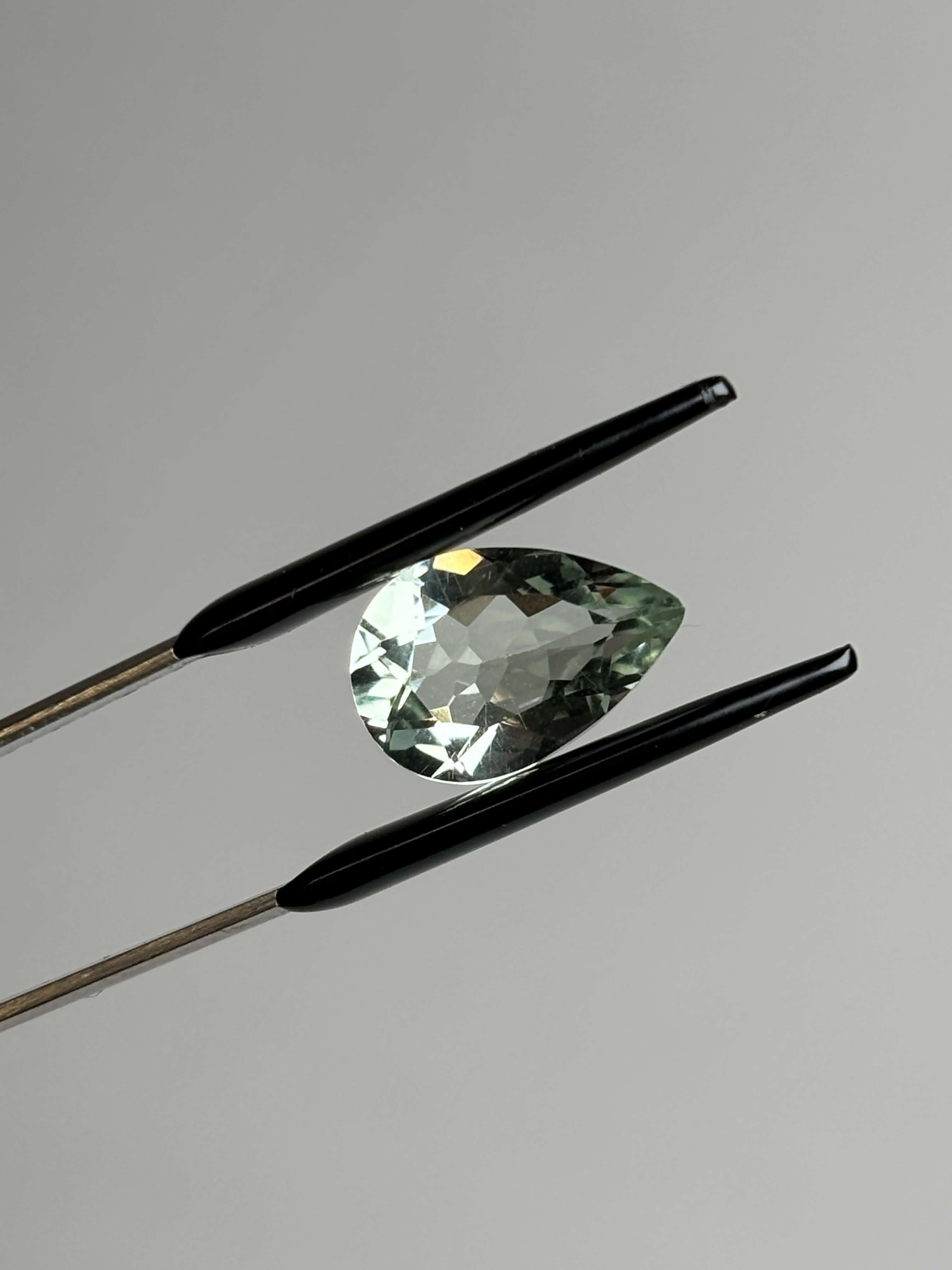 Front of pear shaped light green stone