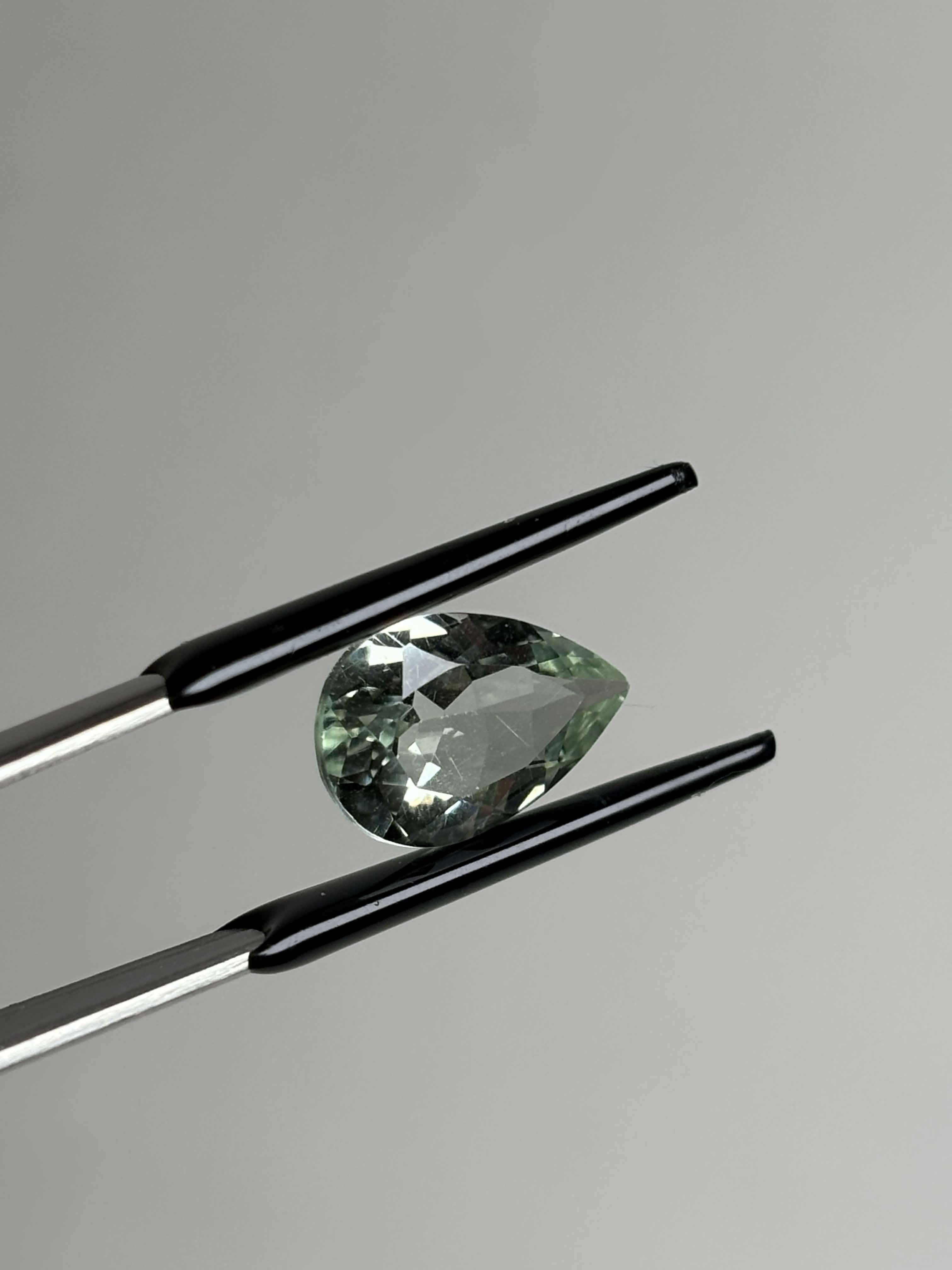 Front of pear shaped light green stone