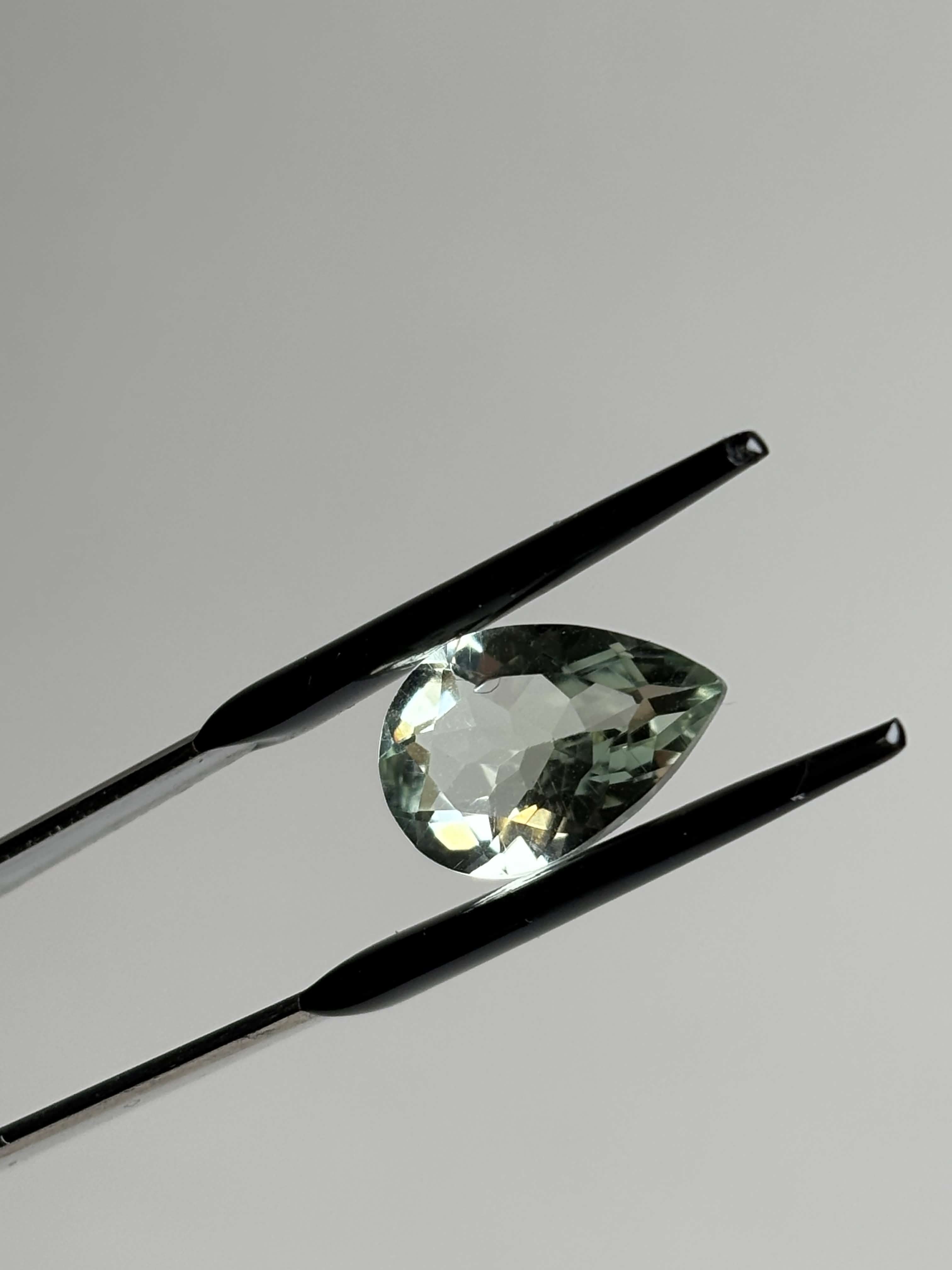 Front of pear shaped light green stone