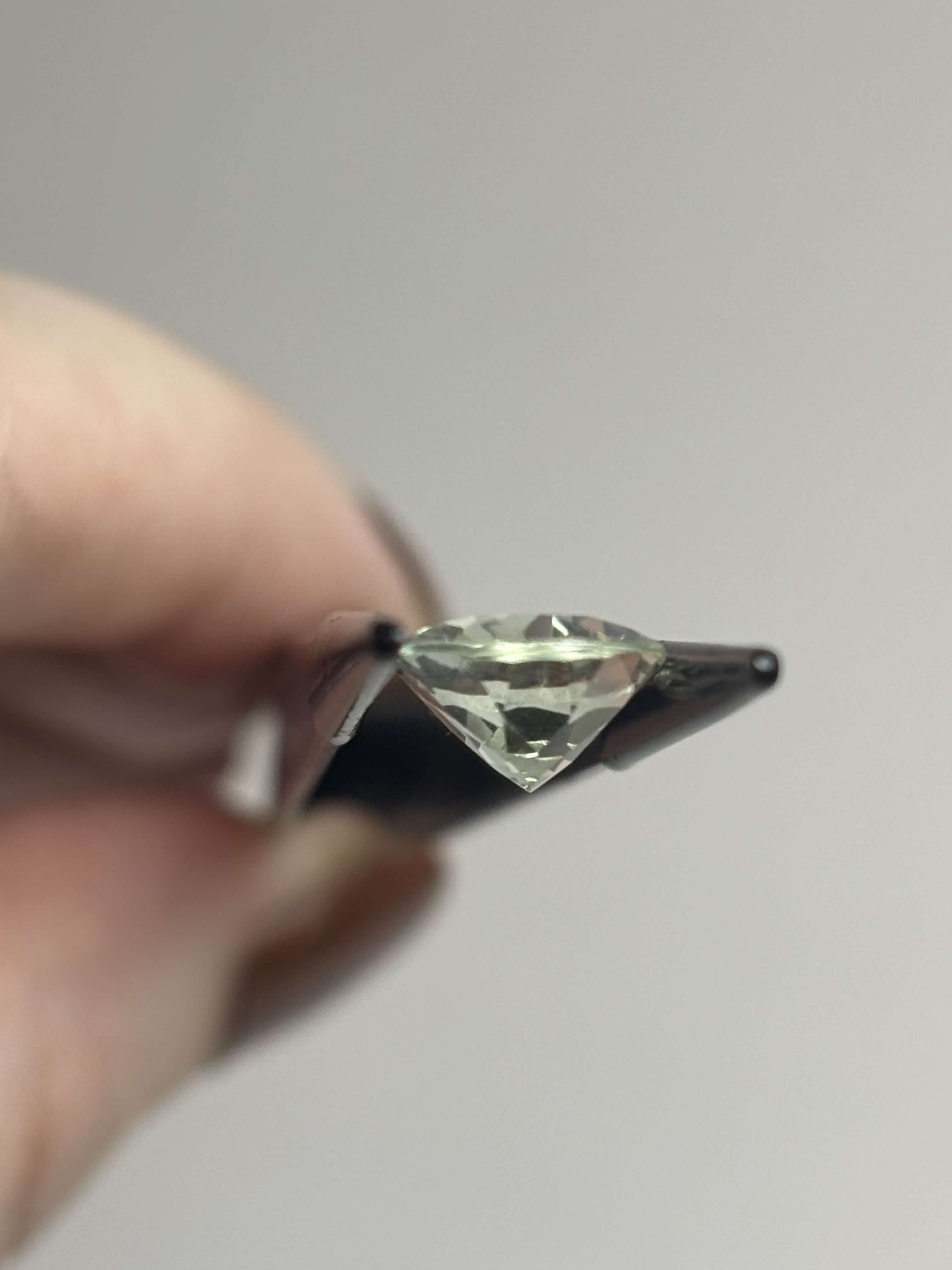 Side of pale green faceted stone