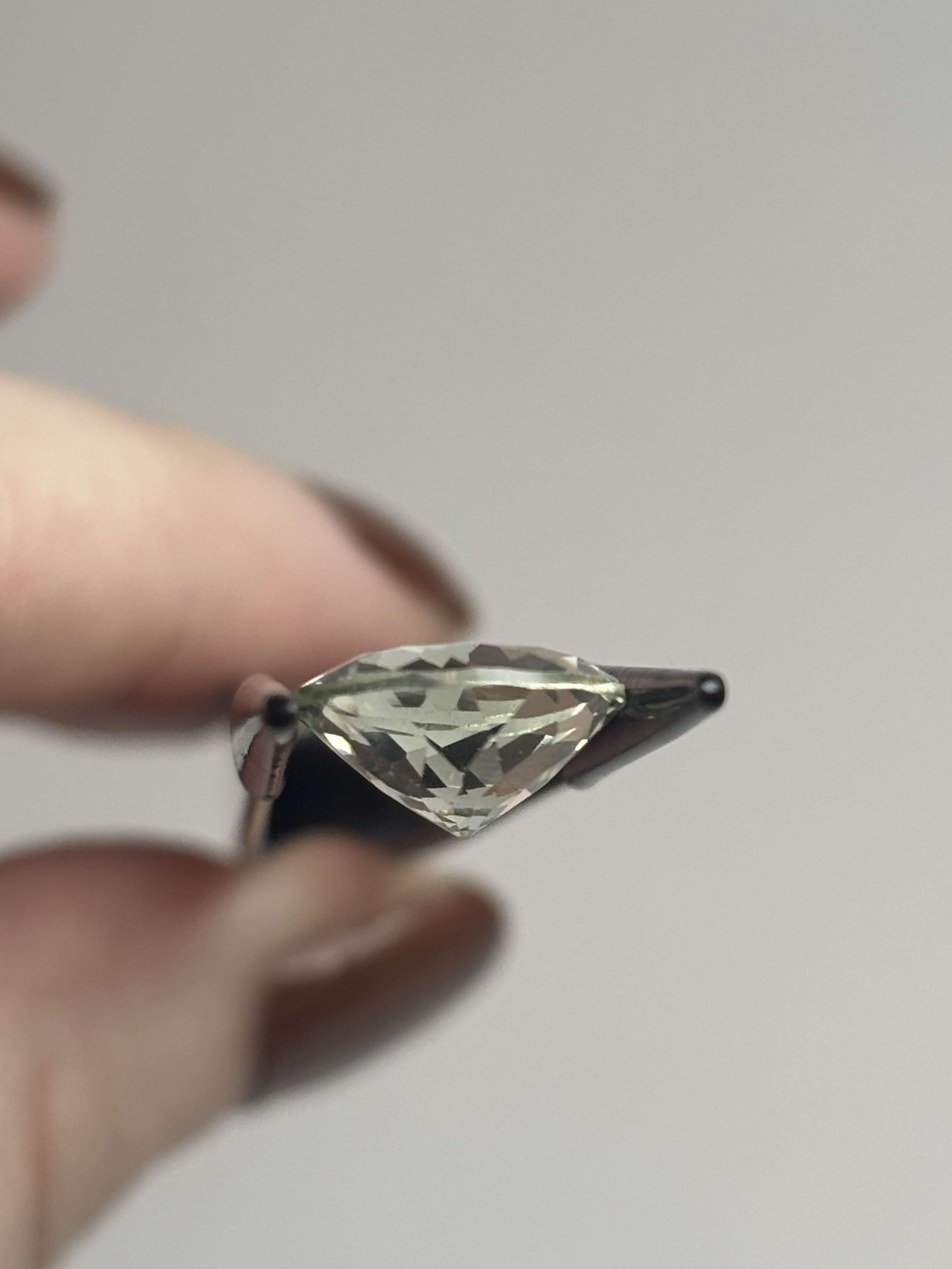 Side of pale green faceted round stone